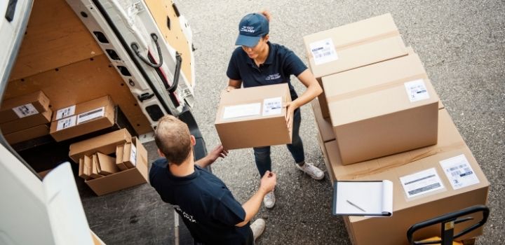Supply only kitchens - people loading van with various sized kitchen parts